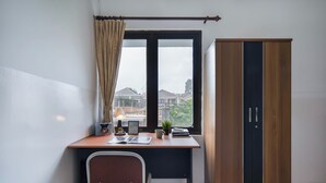 A room with a desk, chair, window, and wardrobe. - Cove Horizone (Bandung)