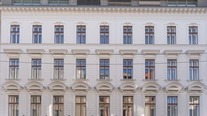 Un edificio blanco con varias ventanas y balcones.