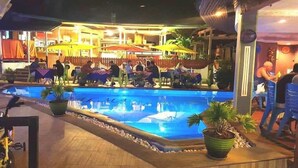 A poolside area with outdoor seating and umbrellas. - La Capannina Ristorante & Hotel Patong (Patong)