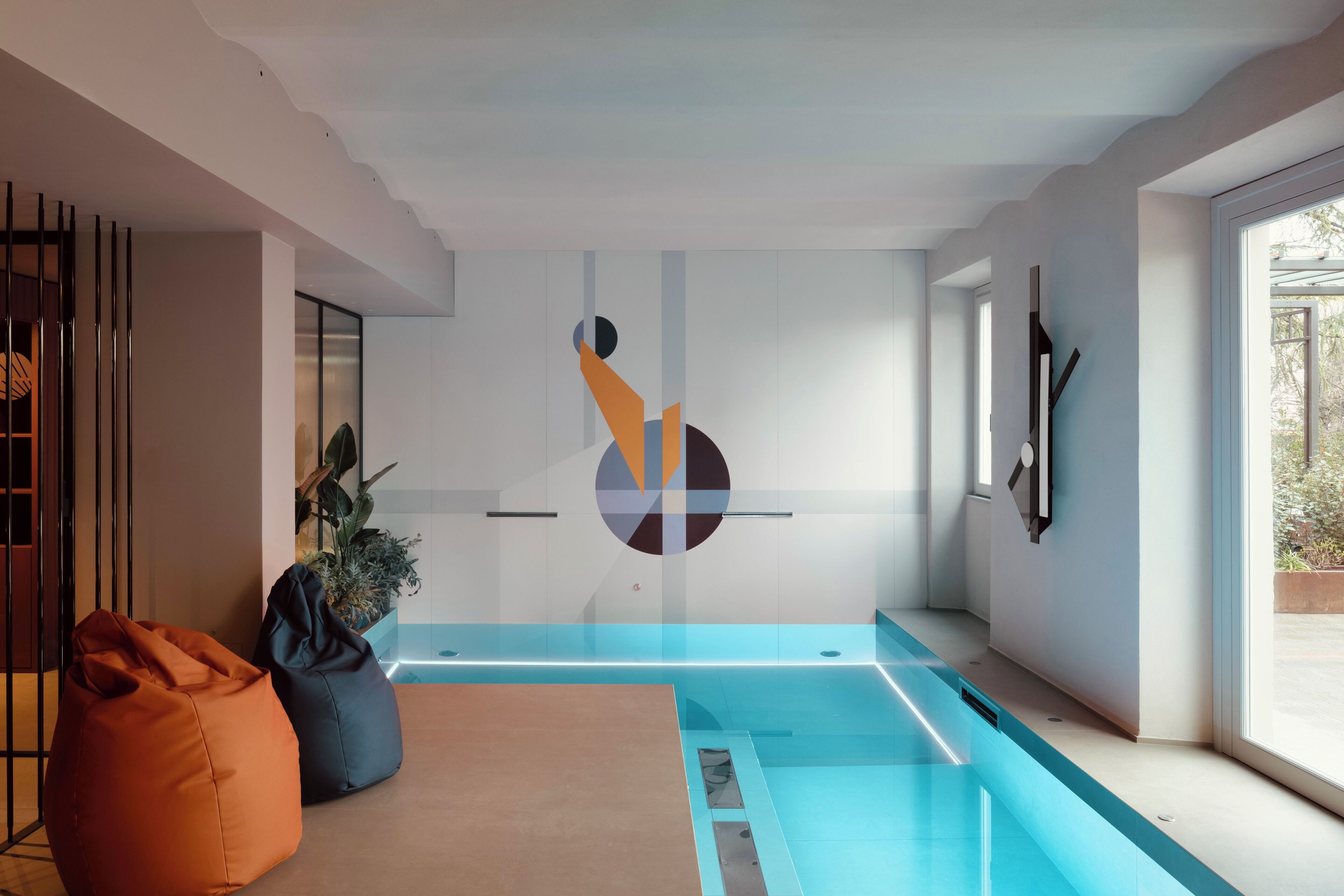 A modern interior with a pool, a bean bag, and a minimalist wall design.