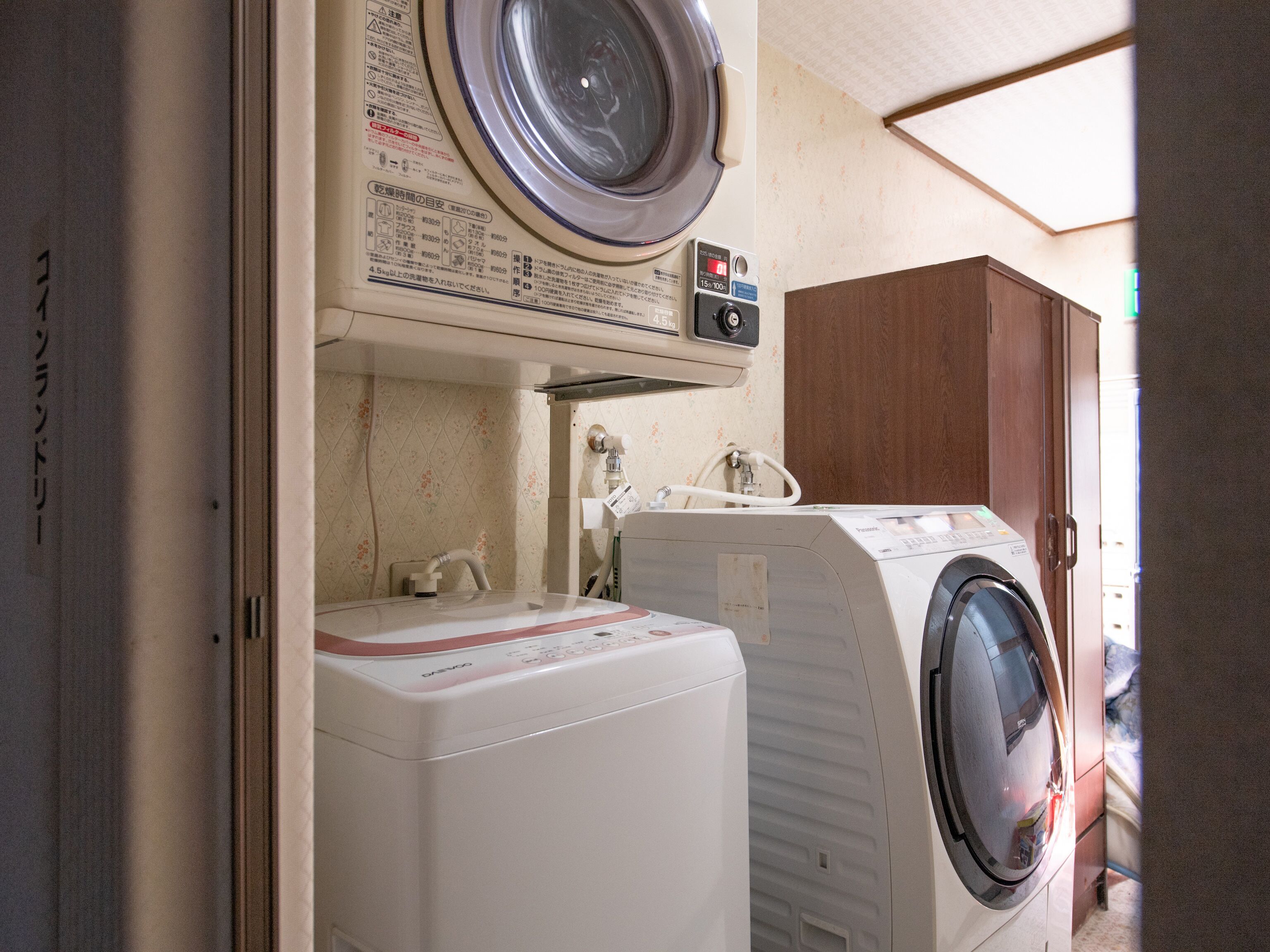 A laundry area with a washing machine, a dryer, and a water heater.