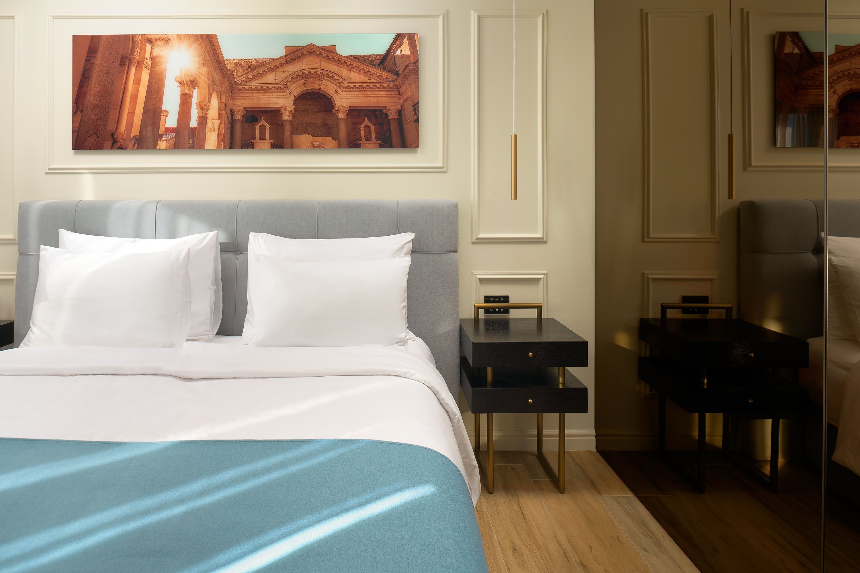 Una habitación de hotel con una cama grande, una mesita de noche, un escritorio y una silla.