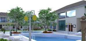 Un hotel moderno con piscina, zona de estar exterior y jardín cuidado.