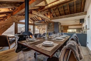Enjoy meals in a spacious dining area with a large table and mountain views.