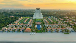 A coastal resort with a central building, multiple villas, and a beachfront. - Fusion Resort & Villas Da Nang (Da Nang)