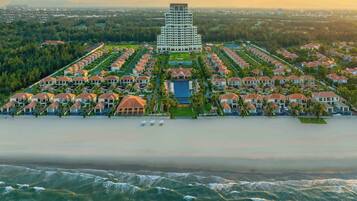 Experience serene beachfront living with a pool area and a mix of modern and traditional architecture.