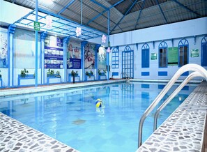 Relax by the pool surrounded by a vibrant atmosphere and amenities.