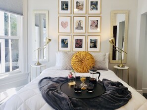 A neatly arranged bedroom with a bed, bedside tables, a coffee maker, and a tray with cups and a teapot. - Somerset  (San Diego)