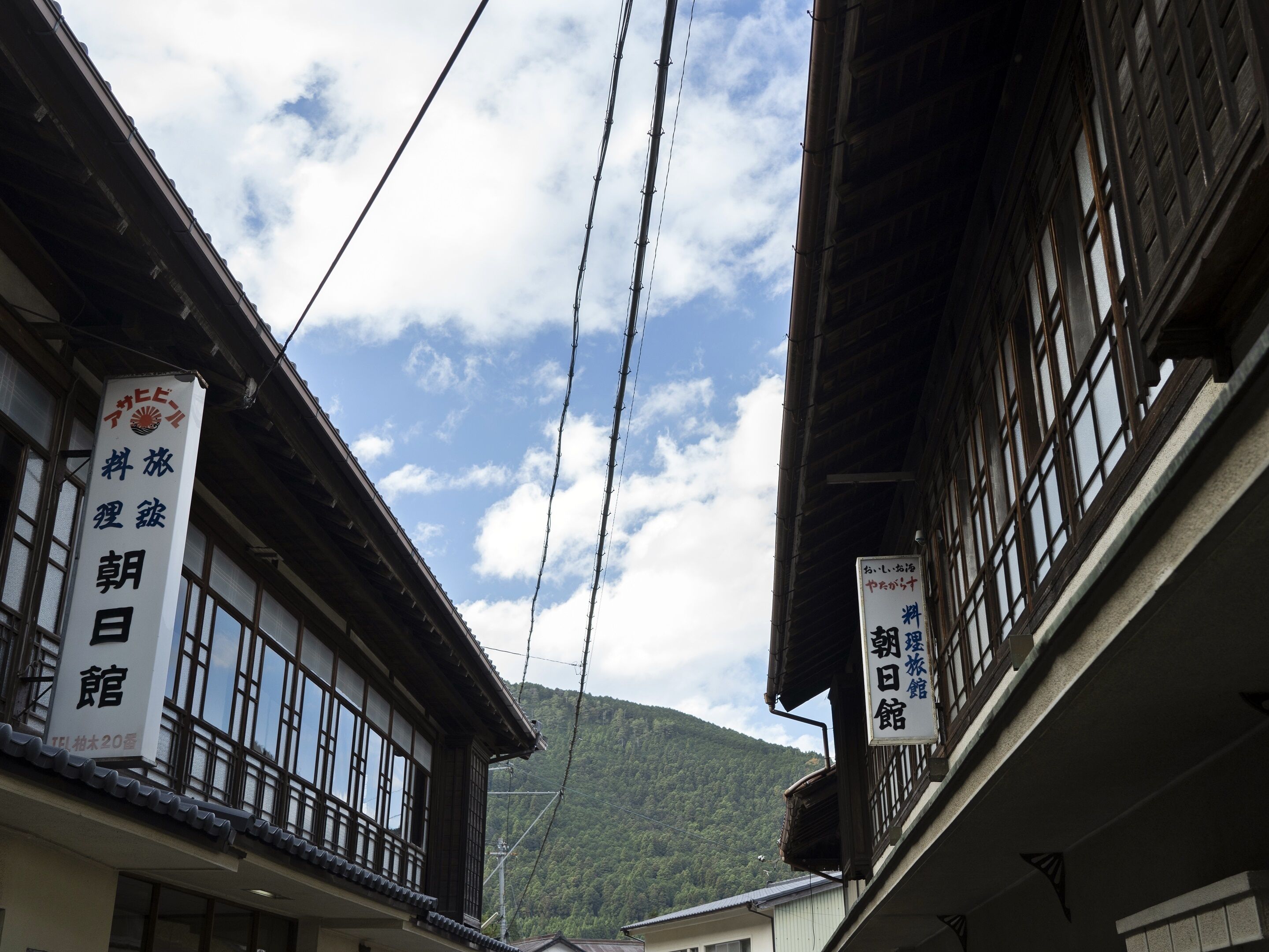 A traditional Japanese building with large windows and a sign indicating it is a hotel.