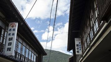 A traditional Japanese building with large windows and a sign indicating it is a hotel.