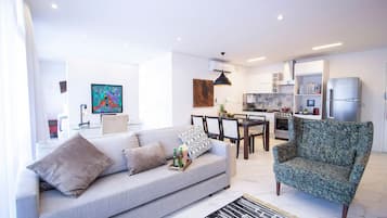 Villa | Living area | 60-inch TV with cable channels