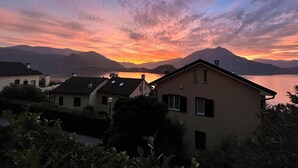 A residential area with houses, a lake, and mountains in the background. - The Terrace on the lake (Fiumelatte)