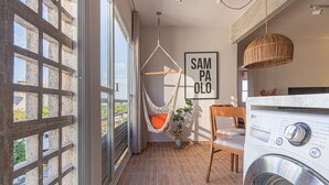 A balcony with a hammock, a washing machine, and a sign that reads "SAMPAOLO". - Vossa Bossa Jardins (São Paulo)