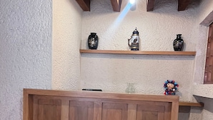 A wooden reception desk with a tiled floor and a rustic ceiling. - Casa en Club de Golf (Tequisquiapan)