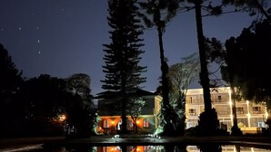 Un edificio de varios pisos, con amplios ventanales y reflejado en el agua.