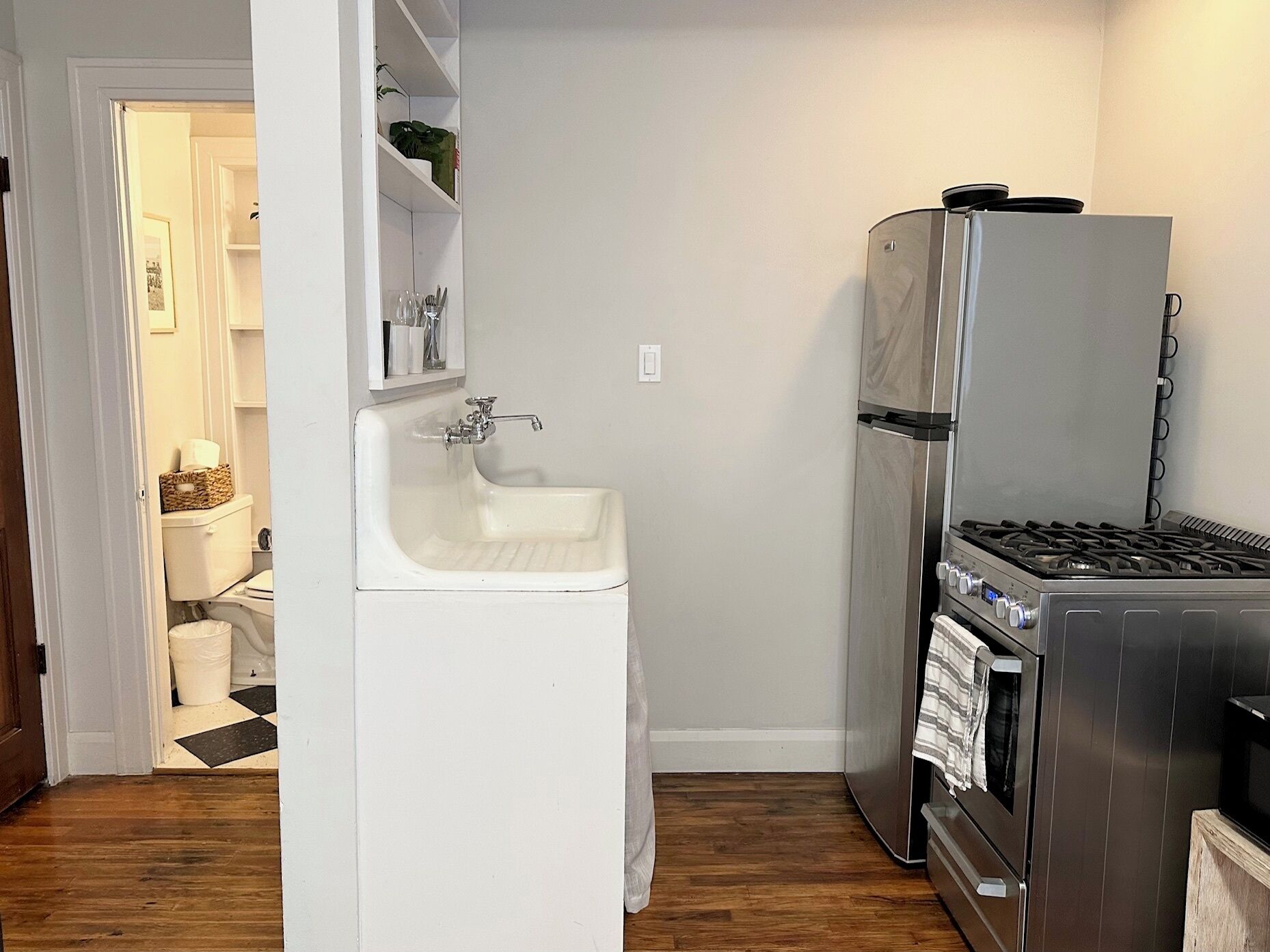 A compact kitchen with a sink, a refrigerator, and a stove.