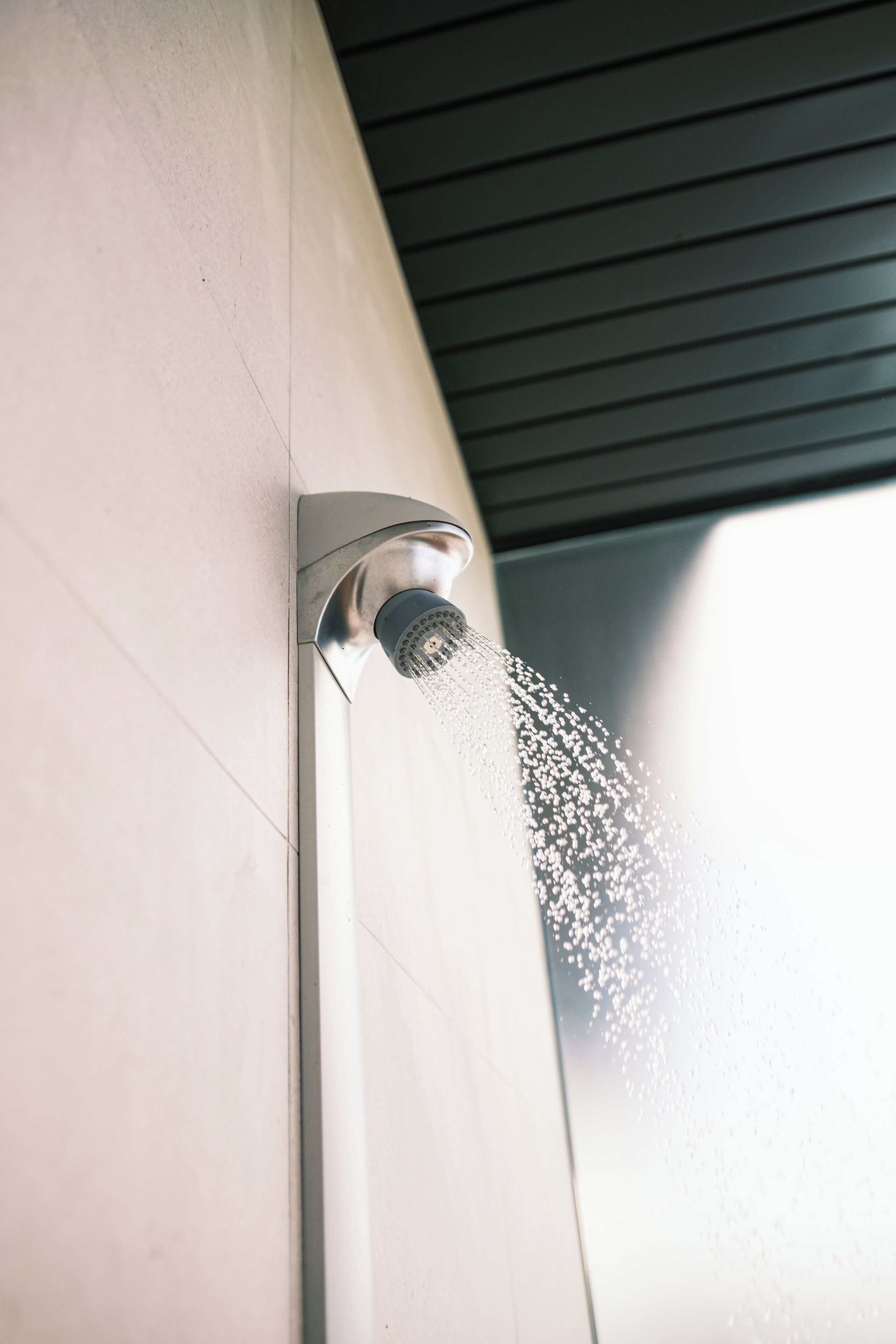 A modern showerhead with water flowing from it.