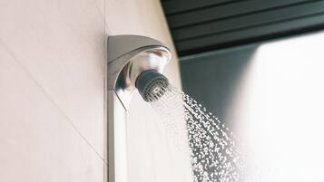 A modern showerhead with water flowing from it.