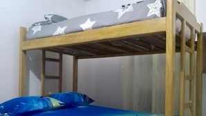 A bunk bed with a star-patterned top rail and a blue ocean-themed bedspread. - Punta Antioquia Hotel (San Juan de Urabá)