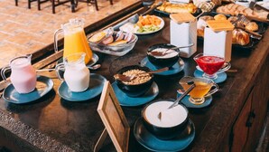 A buffet setup with various food items and beverages.