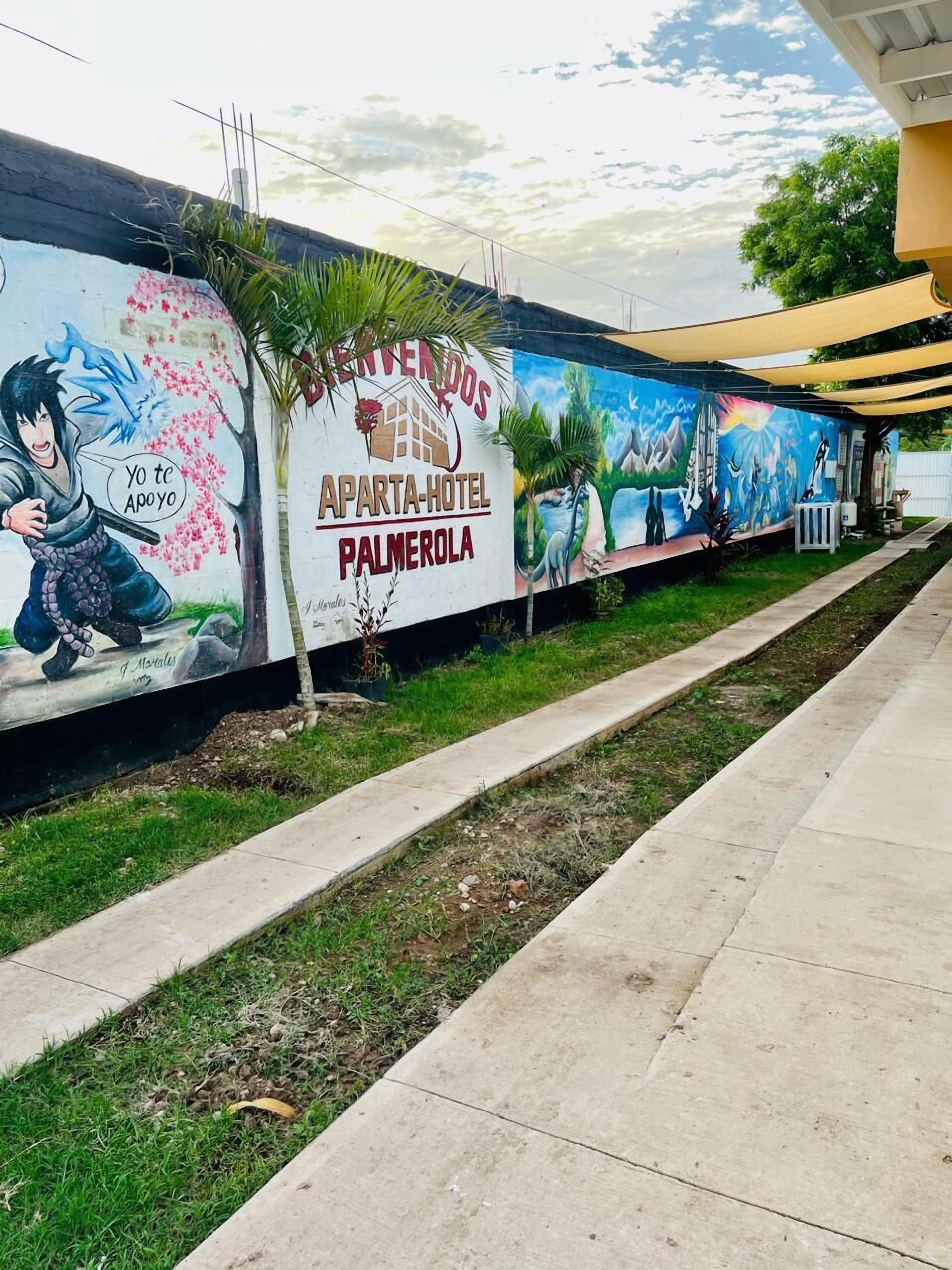 A mural advertising the Apartha-Hotel in Palmero, featuring a warrior and a colorful landscape.