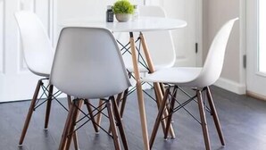 A dining area with a round table, white chairs, and a pendant light. - Private & Clean Retreat Near Lackland AFB | Pet-Friendly & Family Ready! (San Antonio)