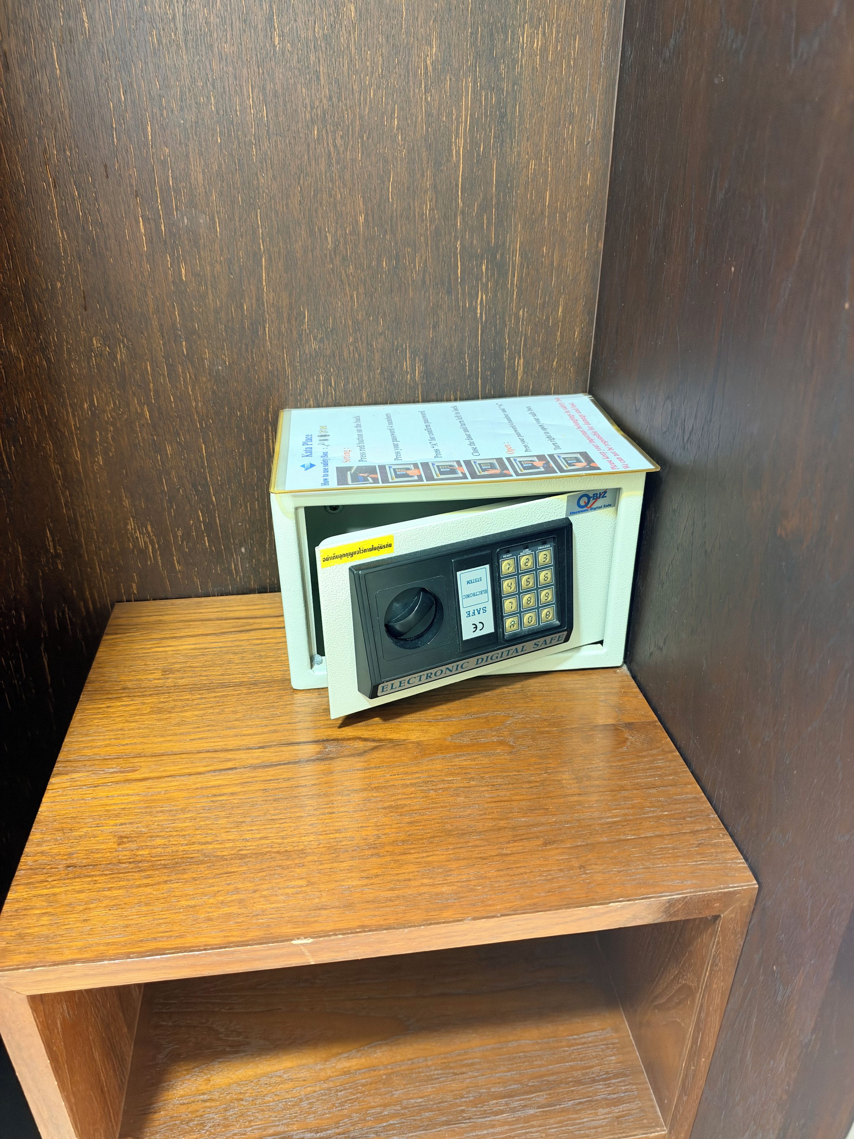 A small wooden table with a box on top, possibly containing a device or product.