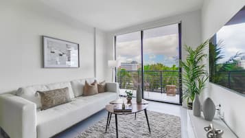Deluxe Apartment | Living area | 50-inch Smart TV with cable channels