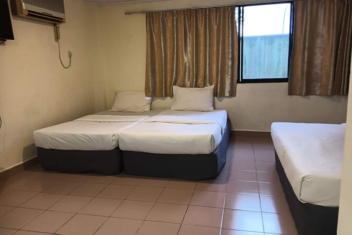 A room with two beds, a window with curtains, a wall-mounted air conditioner, and tiled flooring.