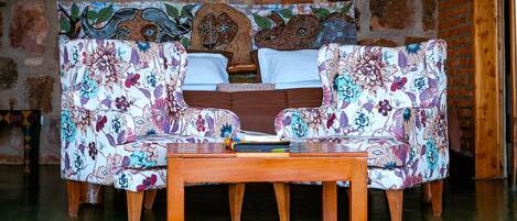 A sofa with floral upholstery and a wooden coffee table in front.