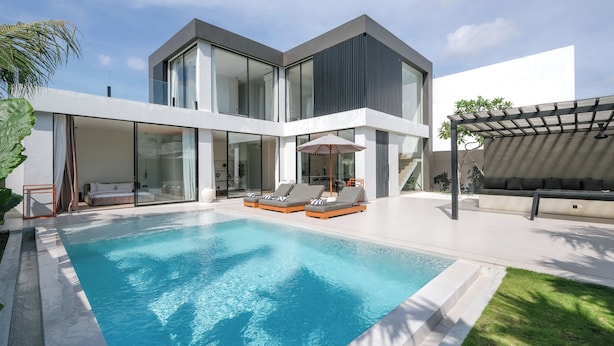 A modern house with a swimming pool, glass doors, and outdoor seating. - Villa Yuna (Canggu)