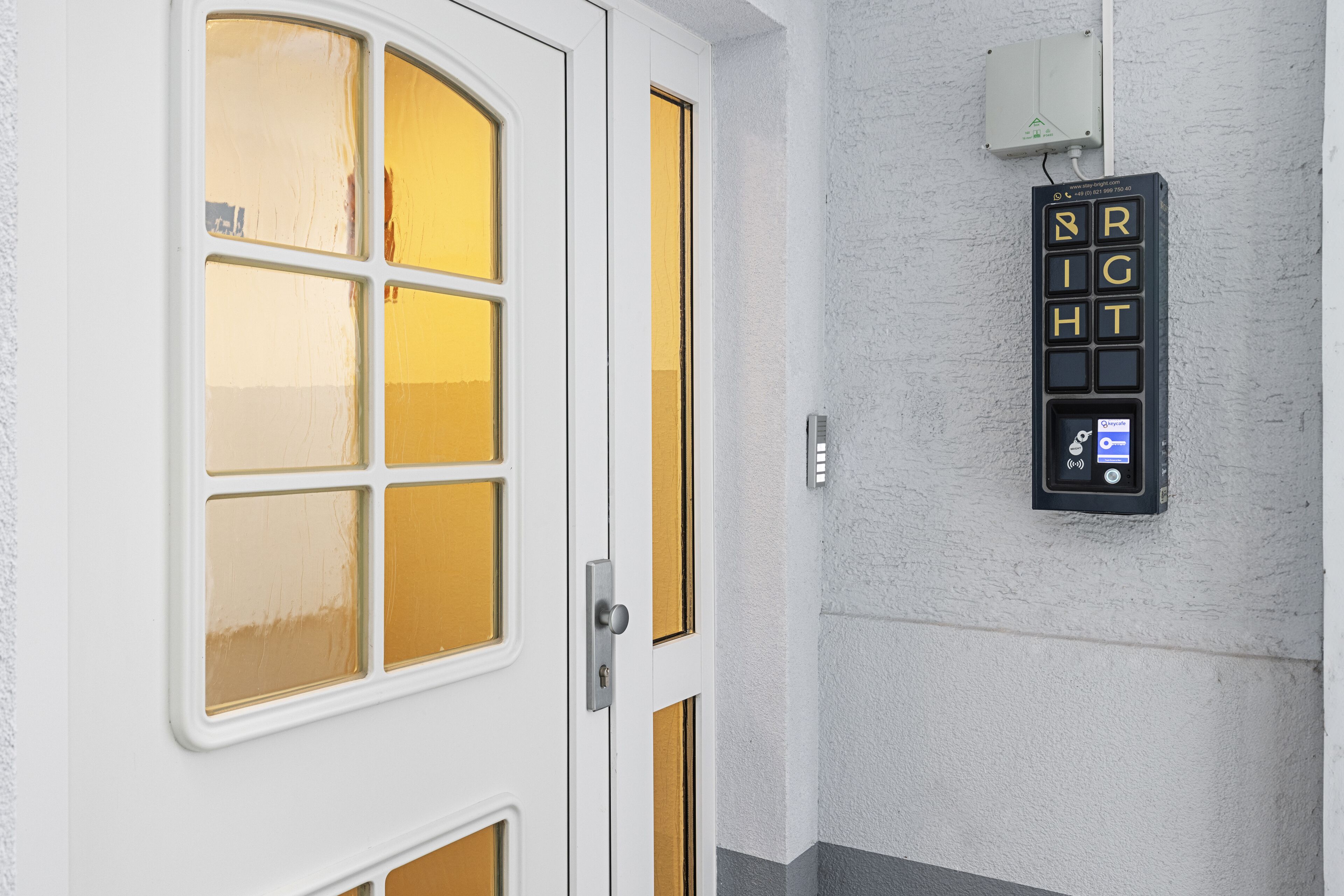 A white door with a glass panel and a wall-mounted light switch with the word "RIGHT" visible.