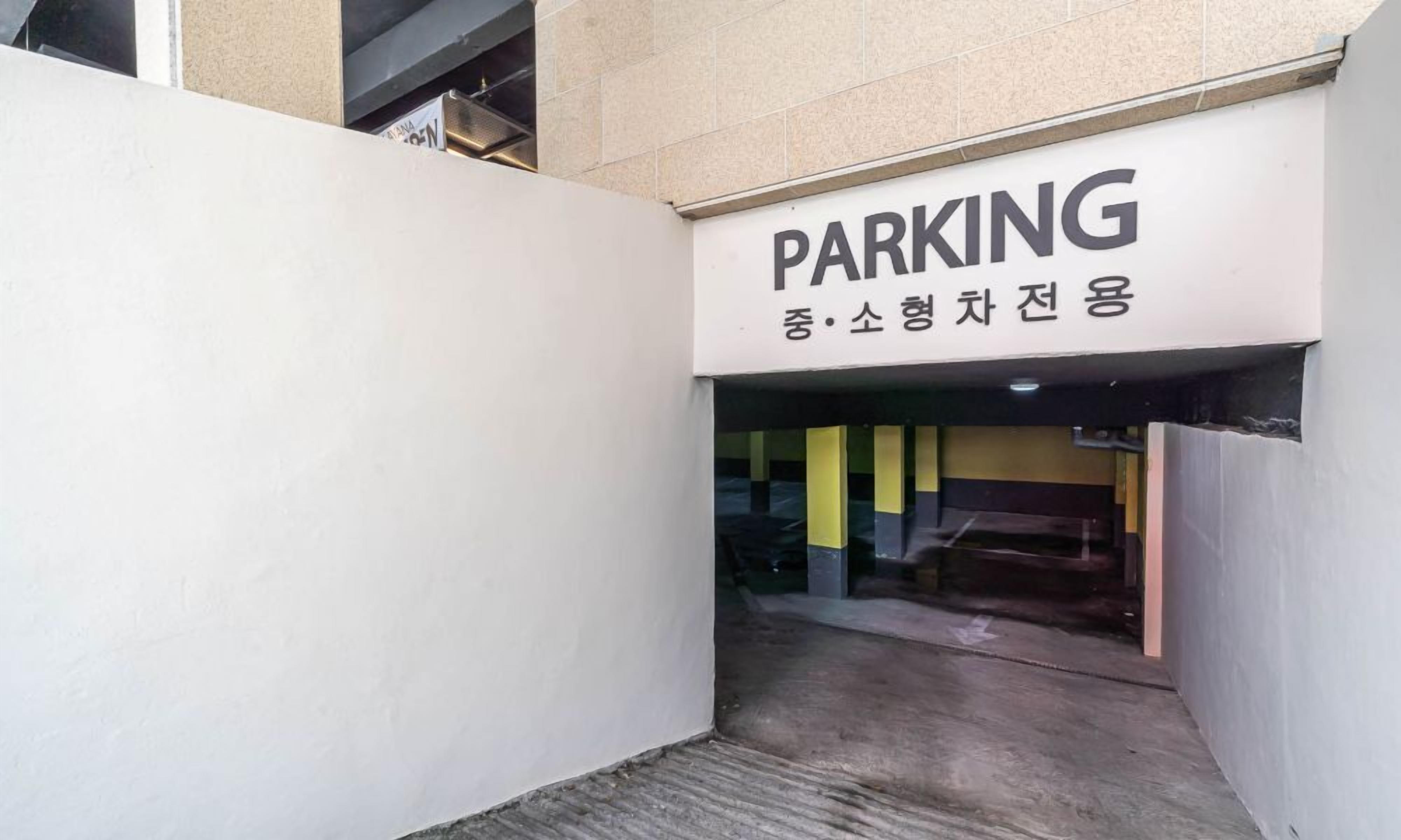 A parking entrance with a sign indicating a parking area.