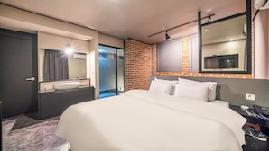 A modern hotel room with a large bed, a bathroom with a sink and mirror, and a TV mounted on the wall. - HOTEL STAY AYANA DAEJEON (Daejeon)