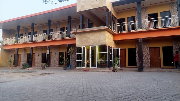 A two-story building with a central open area, multiple balconies, and a covered entrance. - Sasando Residence Kupang (Kupang)