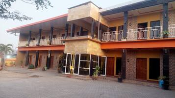 Experience the hotel's modern design, featuring a combination of brick and stone facades, with spacious balconies and a serene courtyard.