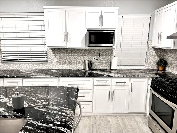Fridge, microwave, stovetop, coffee/tea maker