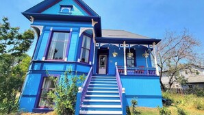 A two-story house with a prominent staircase leading to the entrance. - Barclay Klum House by WanderLodges (Ashland)