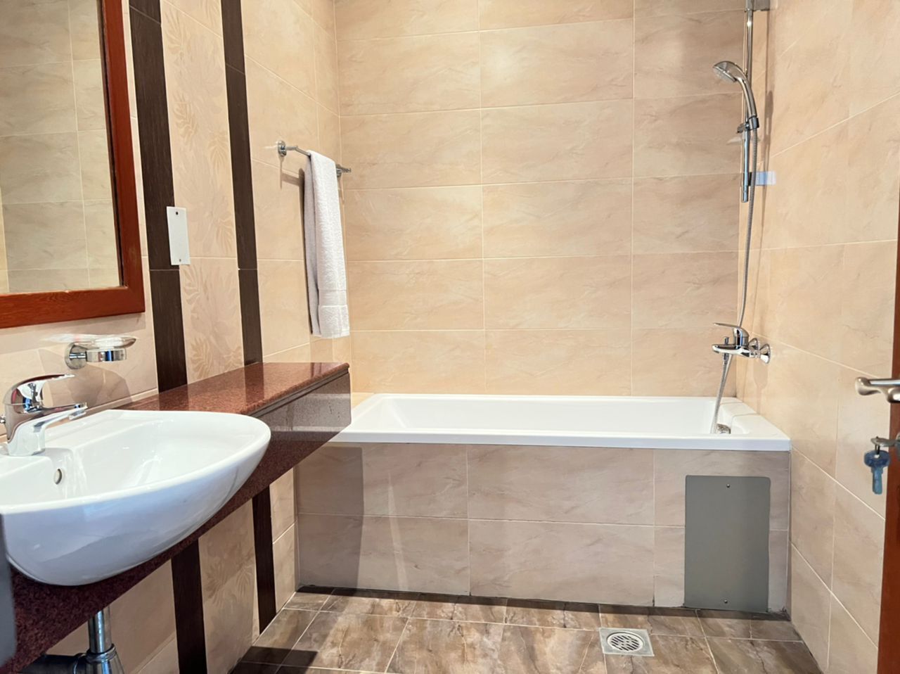 A bathroom with a white sink, a bathtub, and a shower.