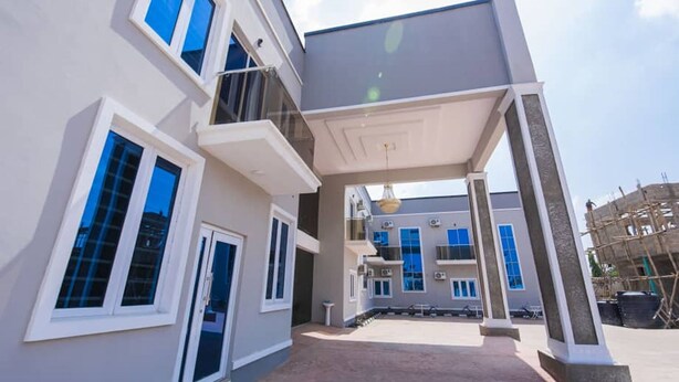 A modern multi-story building with balconies, large windows, and a covered entrance area. - Imperial Boni Hotels and Resorts (Akure)