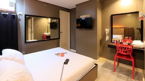 A hotel room with a bed, a desk with a chair, a TV, and a mirror. - Hotel Sogo Fairview  (Quezon City)
