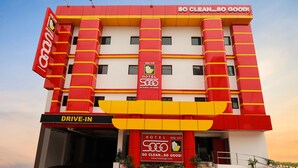 A hotel with a red and yellow facade, a 'Drive-In' sign, and a 'So Clean...So Good!' slogan. - Hotel Sogo Fairview  (Quezon City)