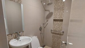 A modern bathroom with a toilet, sink, and shower. - Hotel Sogo Timog 2 (Quezon City)