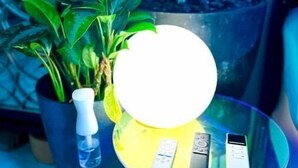 A glass table with a white spherical object and three remote controls. - Accept daily stays NYC West Village Entire Place (New York)