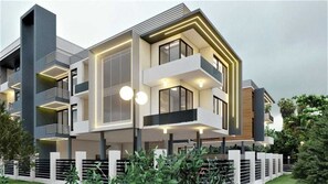 A modern multi-story house with balconies, large windows, and a well-maintained garden.