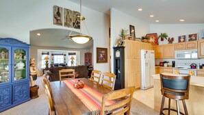 A spacious kitchen with wooden cabinets, a dining table with chairs, and a bar stool. - 6 Mi to Dtwn Yakima: Central Washington Home (Yakima)
