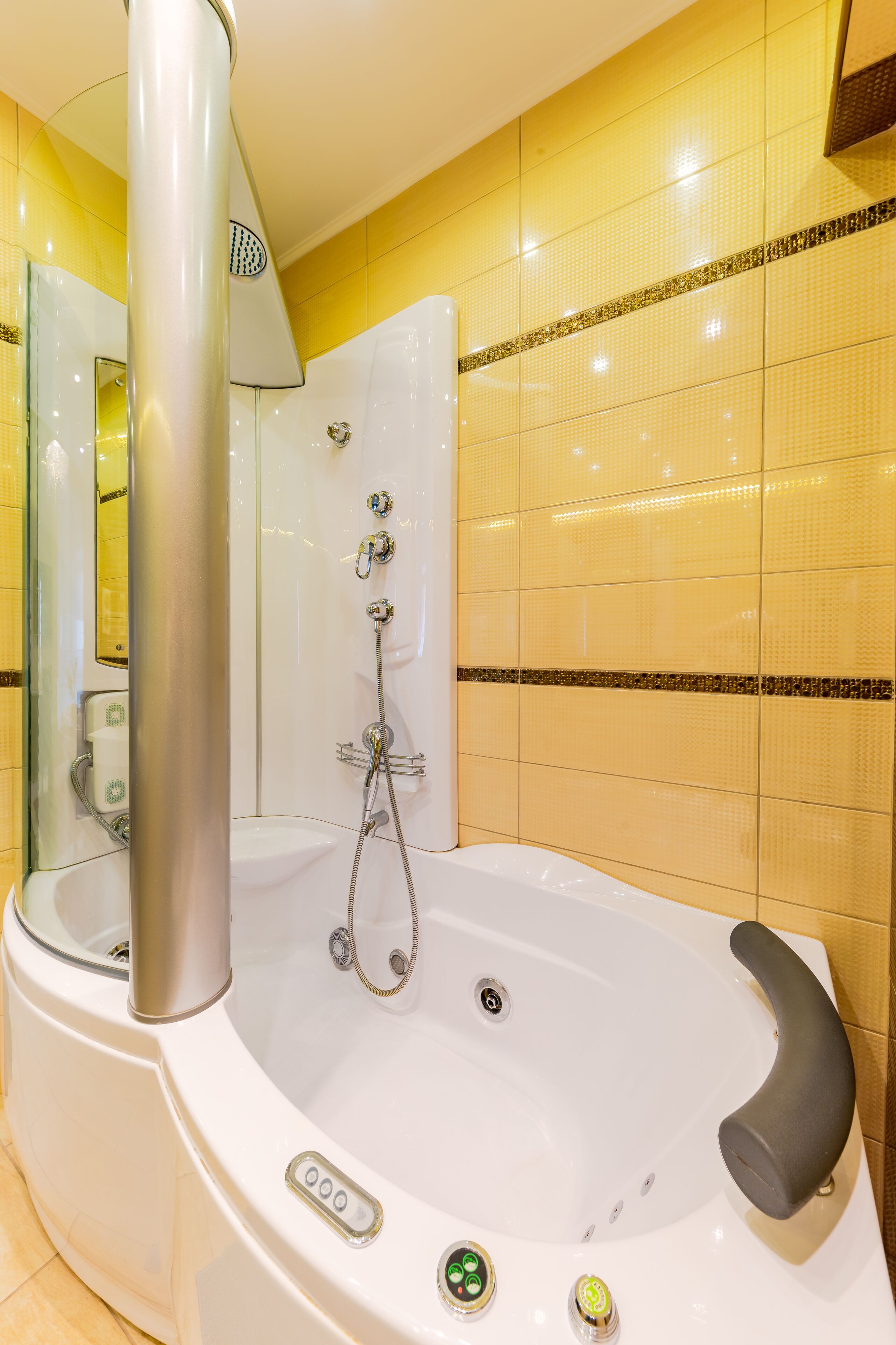 A modern bathroom with a large bathtub, a glass-enclosed shower, and a mirror.