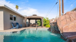 A swimming pool with a gazebo, outdoor seating, and a rock feature. - Luxury Scottsdale Home, walk to Old Town
 (Scottsdale)