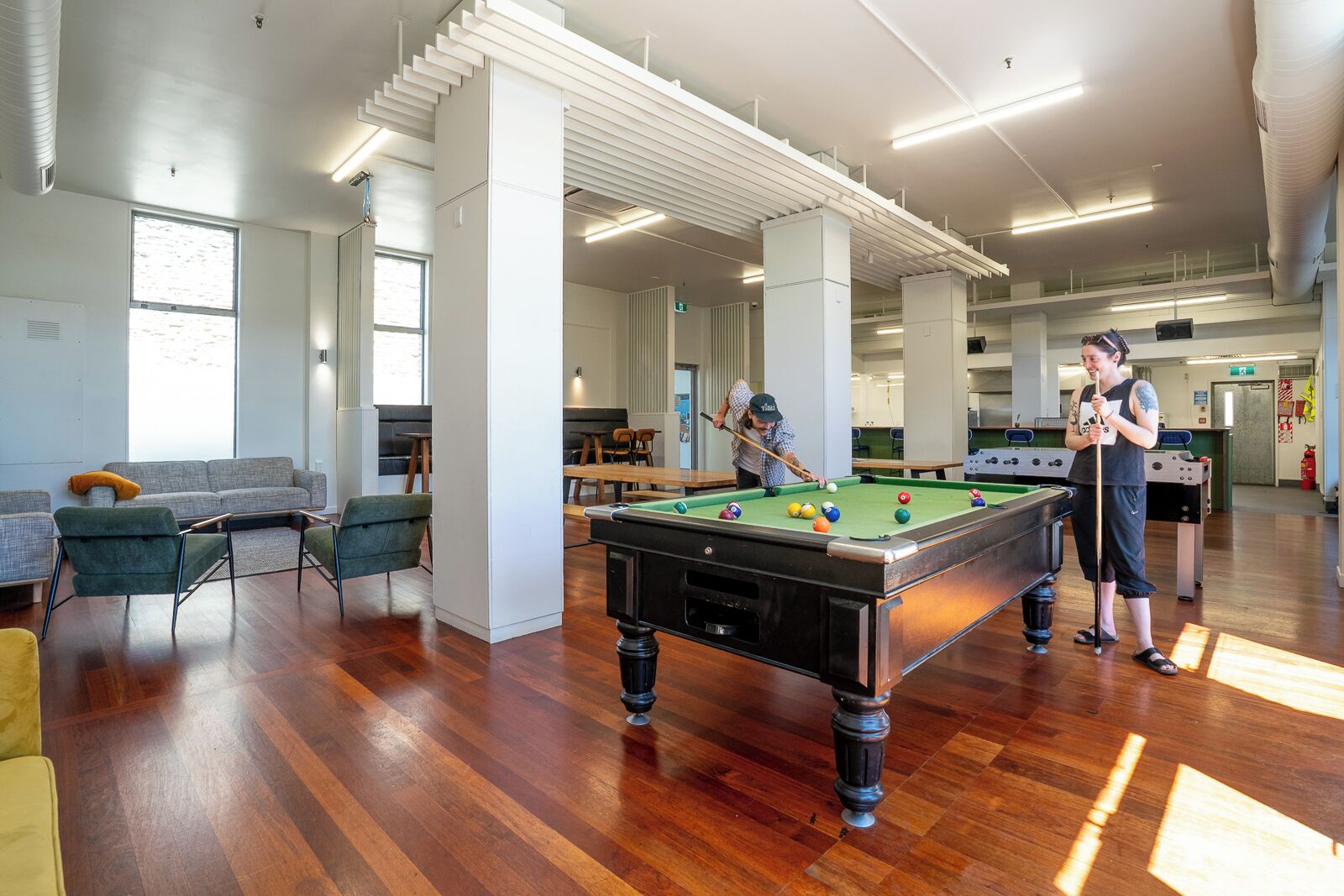 Un espace intérieur vaste et accueillant, doté d’une table de billard, de sièges confortables et d’une ambiance lumineuse et agréable.