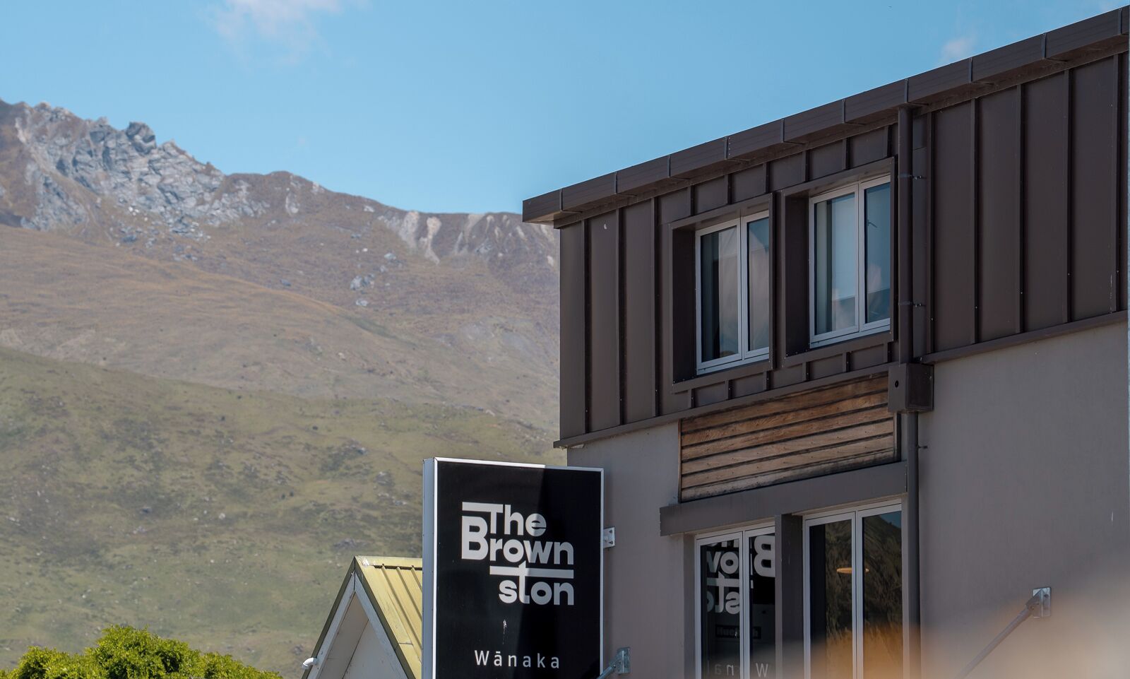 A modern building with a sign reading "The Brown Store" in Wānaka.